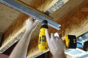 Dill holes to secure board to ceiling joists