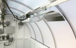 Kush Cottage grow lamp automation including LightRail light movers on each side of the center aisle.